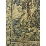 A French made 17th Century style verdure Tapestry with central bird and fruit and flower border.