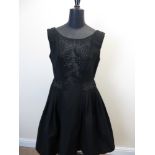 A Hartnell black velvet and satin 1960’s mini Dress with feature buttons, a beaded crepe c1930, a