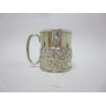 A Victorian silver Christening Mug embossed birds and scrolls, London 1893, maker: Wm Comyns