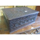 A carved oak Bible Box in the 17th Century style with all over geometric design and panels carved