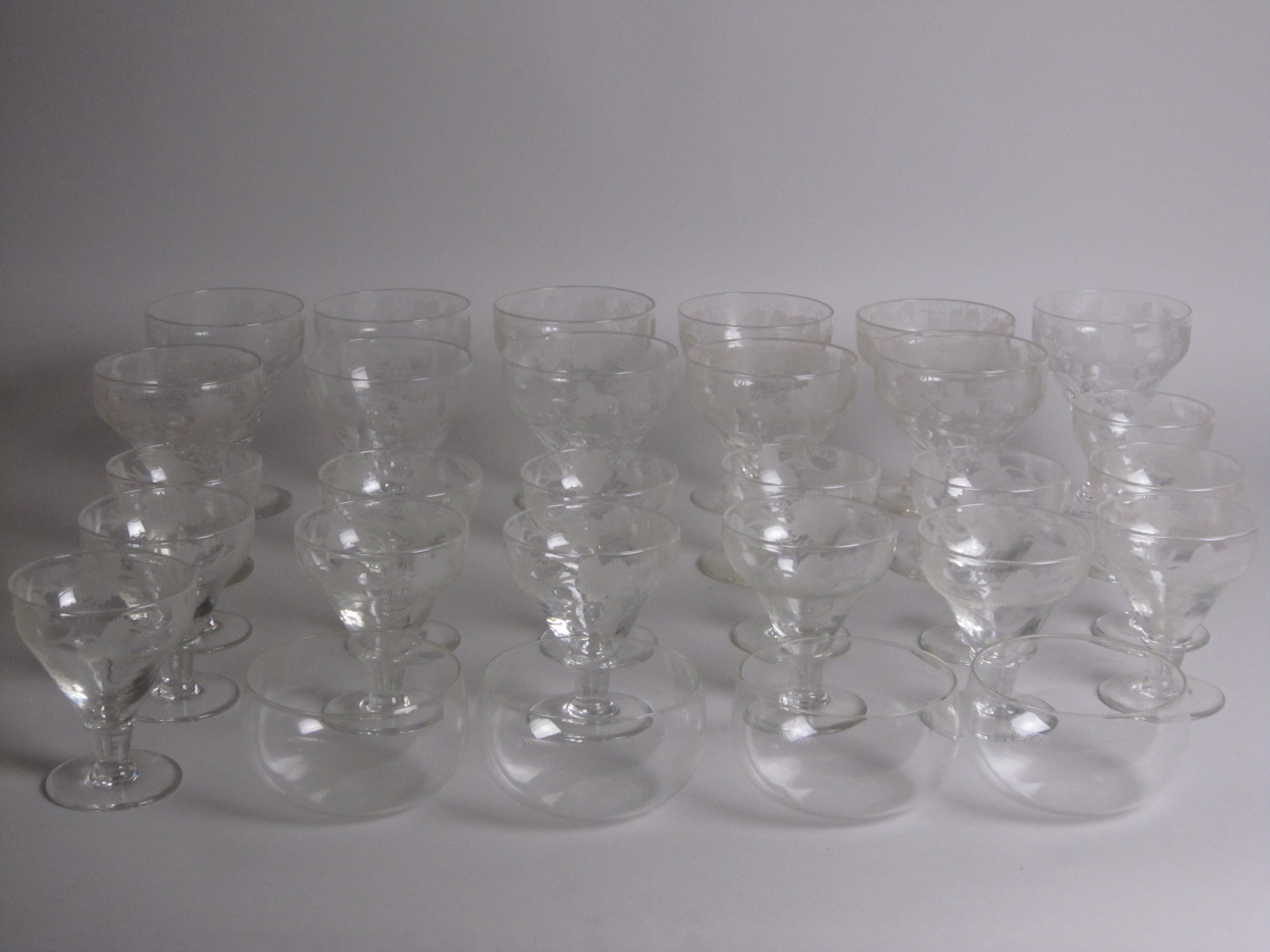 An engraved suite of Glasses, vine leaf designs, viz: eleven various Rummers, fourteen various Wines