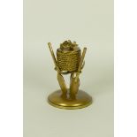 A gilt brass Inkwell on a nautical theme with rope and paddles on a circular base, 6in H