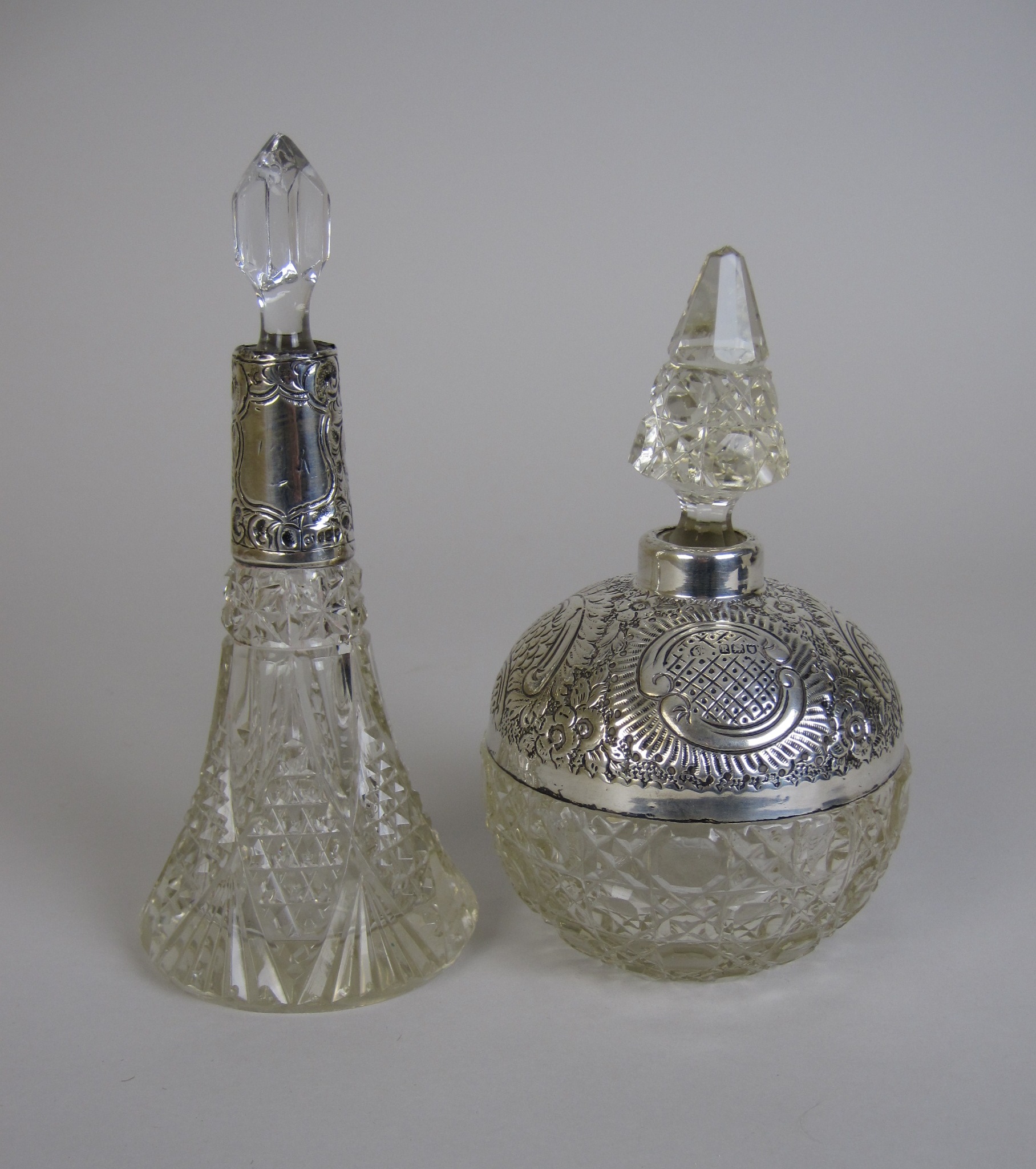 A silver mounted globular cut glass Scent Bottle, London 1905, 6 1/2in H and a silver collared cut
