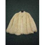 A cream Fur Coat labelled Jacques St Laurent Paris & New York. 1960’s