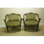 A pair of Victorian carved mahogany Library Chairs with green upholstery on scrolled supports