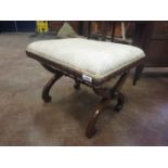 A Regency carved rosewood Stool, the stuff over top and shaped rails on X frame supports united by a