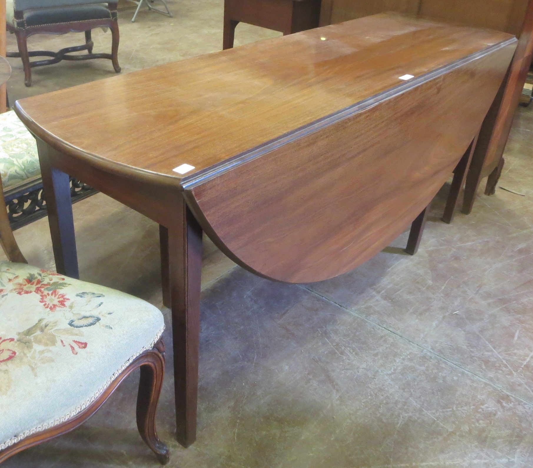 A 19th Century mahogany dropleaf Dining Table with oval top on squared tapering supports, 5ft 6in