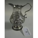 A George II baluster silver Cream Jug with scroll handle, later embossed scroll and floral