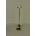 A brass claw Doorstop with loop handle, 16 1/2in H