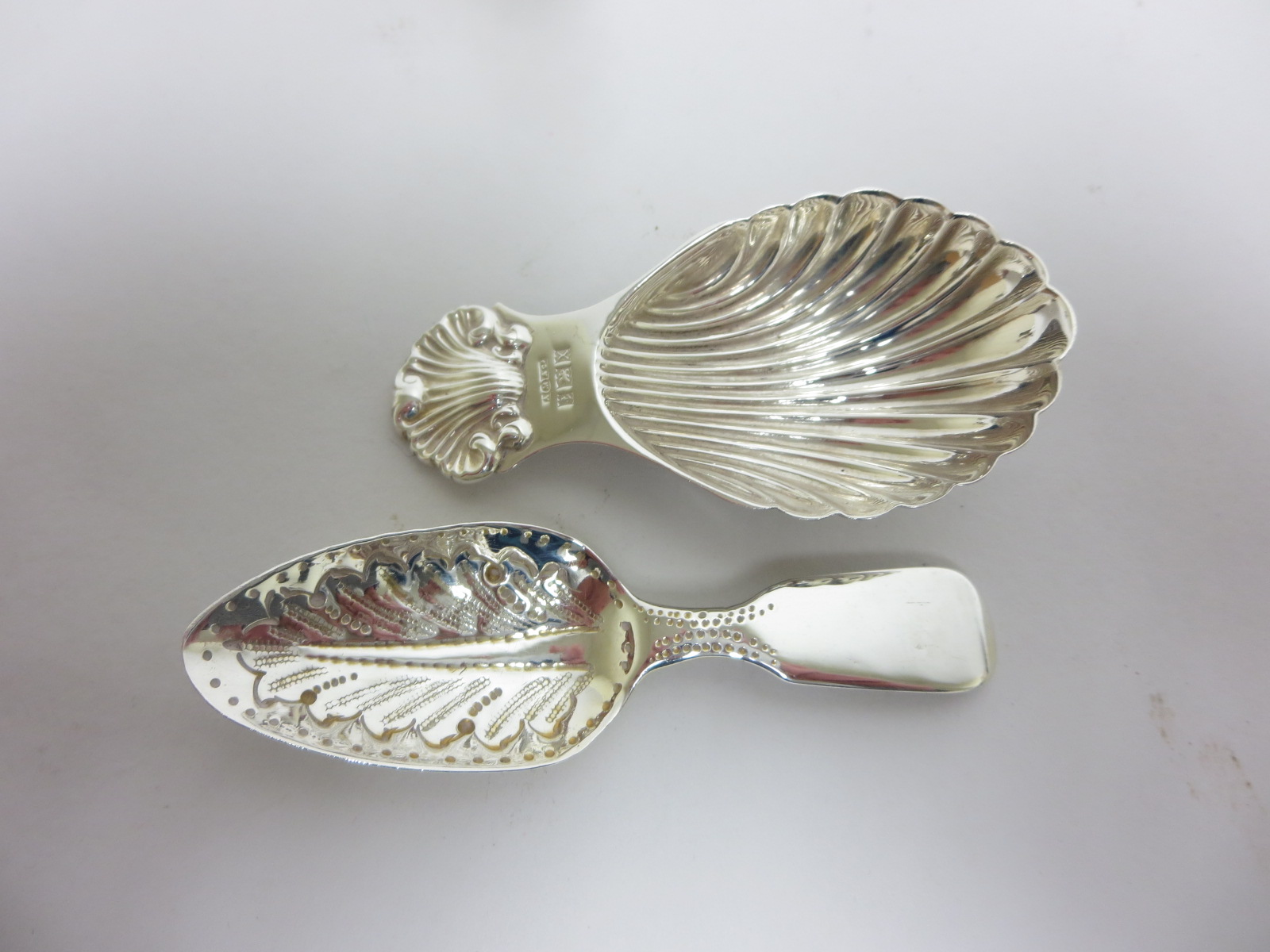 A George IV silver Caddy Spoon fiddle pattern with leaf bowl, London 1824, and another with shell