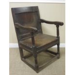 A 17th Century oak Wainscot Armchair with panelled back on turned front supports and squared