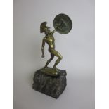 A bronze Figure of a Gladiator with raised circular shield, mounted upon stone base, signed R.