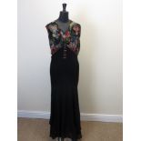 A metallic and polychrome printed 1920’s full length Evening Dress with decorative buttons and an