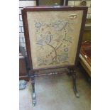 A George III mahogany framed Screen with pull out panels, inset needlework of bird amongst branches,