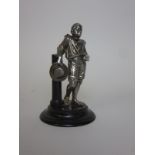 A white metal hollow cast Figure of a negro boy holding a wide brimmed hat, 6in H