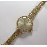 A Lady’s 9ct gold Tudor Wristwatch, on integral Rolex bracelet, champagne dial, with baton