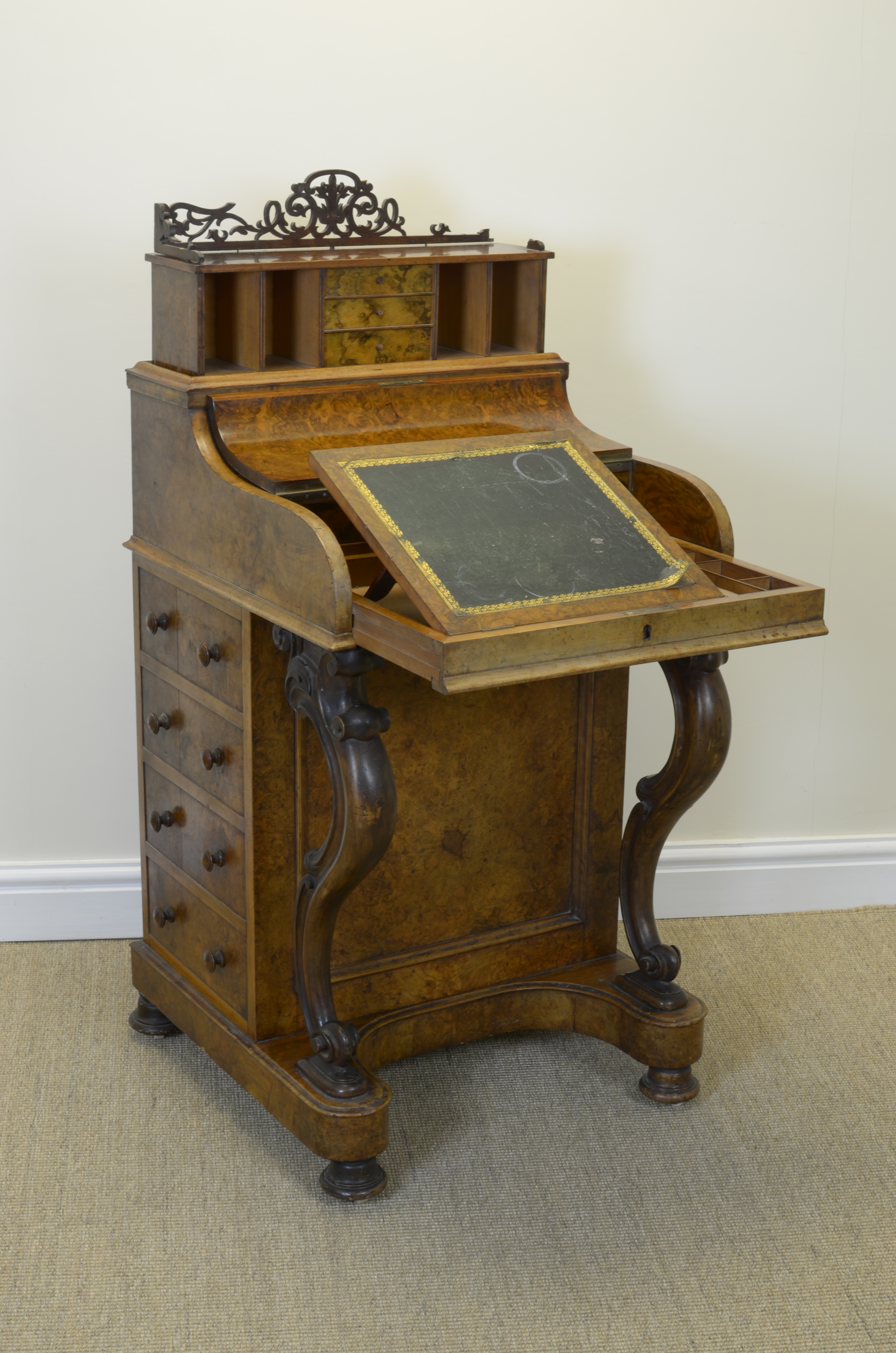 A Victorian burr walnut piano top Davenport with rising top fitted drawers and pigeon holes, pull-