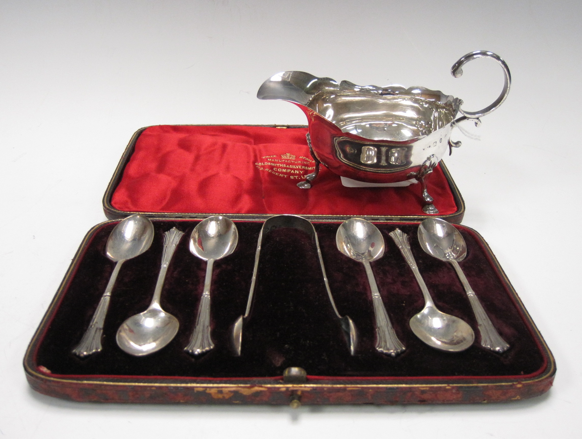 A Victorian silver Cream Jug with scalloped rim on hoof feet, Birmingham 1893 and a set of six