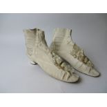 Pair of cream ribbed silk elastic sided ladies Boots with ornate fringed and buckled rosettes.