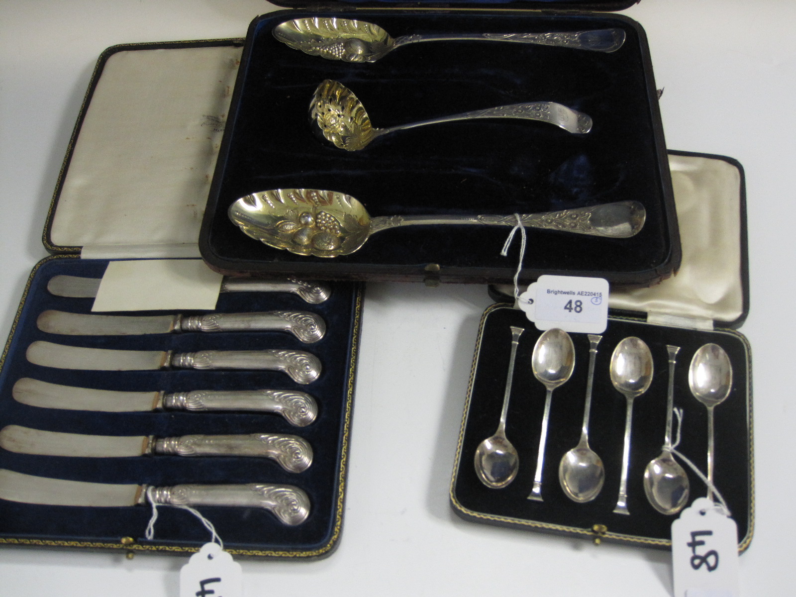 A pair of George III silver Berry Spoons with later embossing and a matched Straining Spoon,