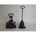 A black painted cast iron bell shaped Doorstop with twisted long handle, and another in the form