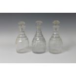 A Pair of Georgian cut-glass Decanters and Stoppers with faceted necks and thumb cut design, 10in H,
