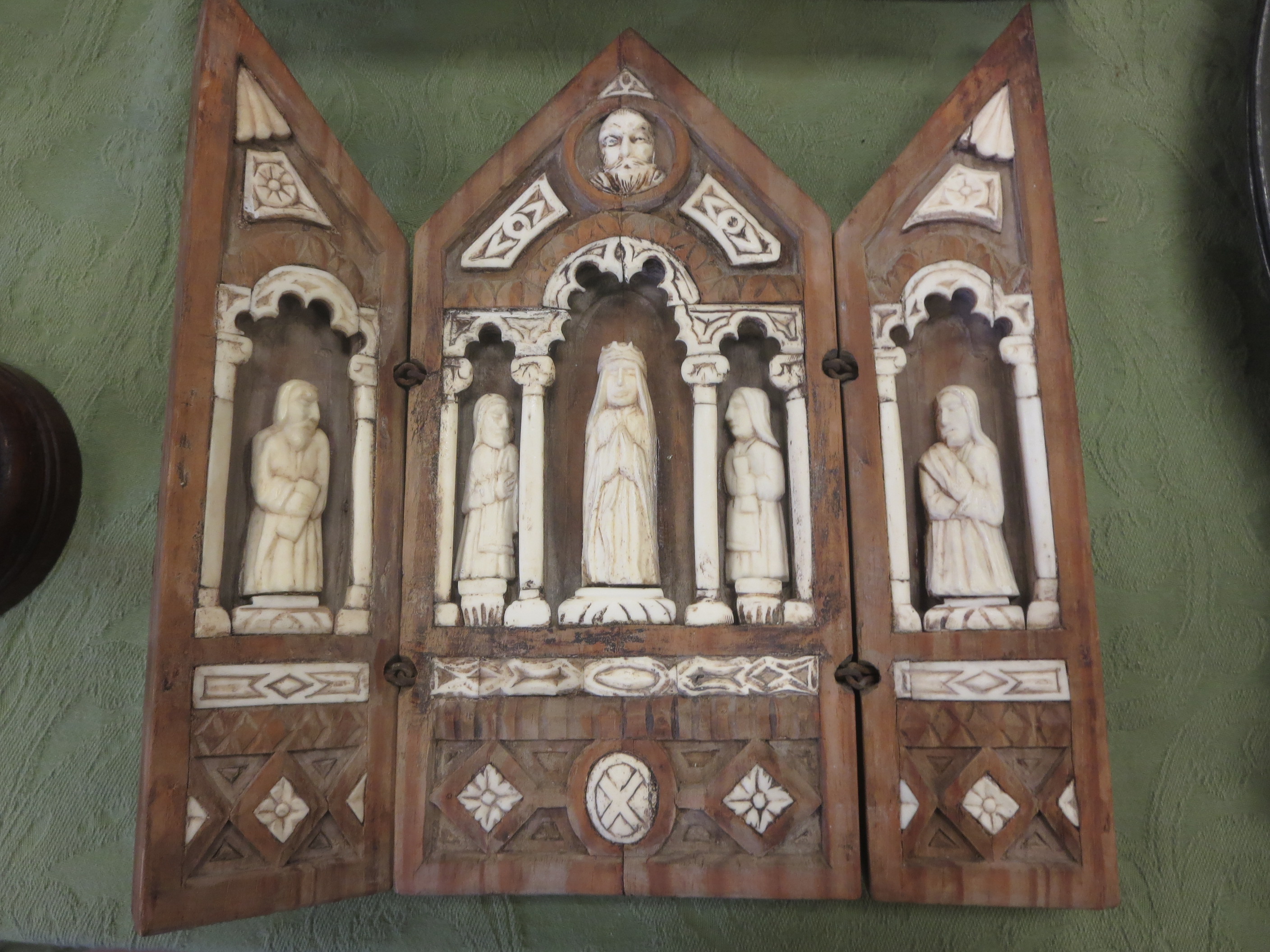 A Continental mediaeval style Triptych with wooden frame (originally painted) enclosing praying