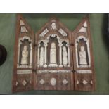 A Continental mediaeval style Triptych with wooden frame (originally painted) enclosing praying