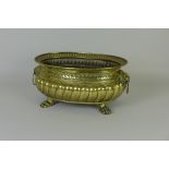 A 19th Century Flemish brass Jardiniere of oval form, lion mask ring handles, gadroon rim on paw