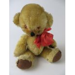 A Merrythought golden fully jointed Teddy Bear with bells in ears. Velour snout.