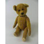 A gold Yes/No Schuco Teddy Bear with boot button eyes. The head activated by the tail. 1930’s.