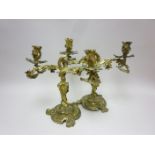 A pair of 19th Century gilt-metal two branch Candesticks on leafage scroll rococo bases, 13in