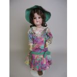 A bisque headed Armand Marseille Doll with blue sleeping eyes and the original wig. Purple