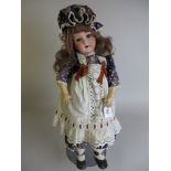 A German bisque headed Doll with sleeping brown eyes and fully jointed body. Costumed in a