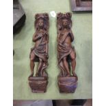 A pair of antique carved figural Pilasters, one holding a cross with scrolled surmounts, 16 1/2in H