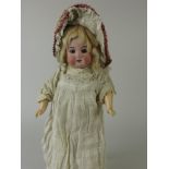 An Armand Marseille girl Doll with sleeping blue eyes and jointed body with fixed wrists. Completely
