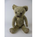 An early Merrythought fully jointed Teddy Bear with original pads. Celluloid button in ear and