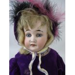 A Cuno and Otto Dressel bisque shoulder headed Doll with fixed blue eyes, bisque lower arms and