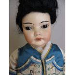 A character bisque Oriental Doll with slanted sleeping brown eyes, original wig. fully jointed body.