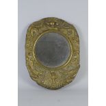 An Arts and Crafts brass Mirror embossed with designs of peacocks, swans and flowers, 19in H