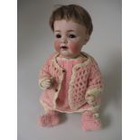 A Kammer & Reinhardt character Doll with bisque head and sleeping eyes. Original wig and pink