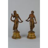 A pair of bronzed Figures, ‘Gaite’ and ‘Modestie’ on turned wood bases, 12in H