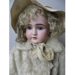 A large German bisque headed girl Doll with sleeping blue eyes, heavy brows, fine original wig and