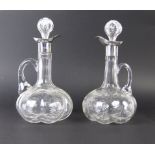 A pair of Edwardian cut glass silver mounted Claret Jugs each of lobed globe and shaft form with