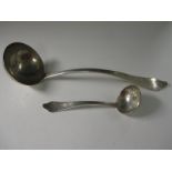 A Victorian silver Soup Ladle and Sauce Ladle with trefoil ends, engraved crest, rat tail bowls,