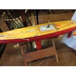 A radio controlled wooden single masted Racing Yacht with red painted hull and weighted keel, 4ft