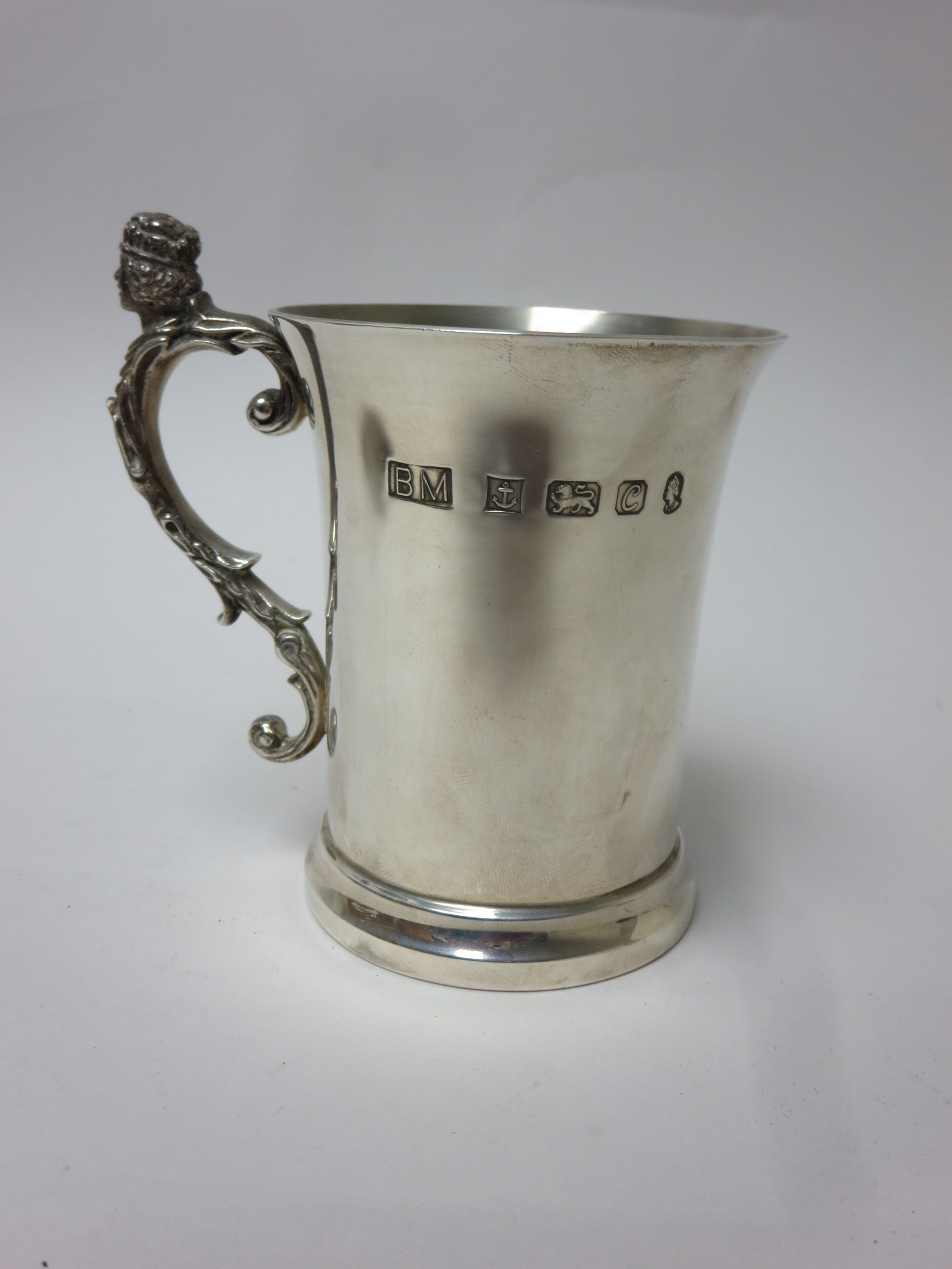 A Queen Elizabeth silver jubilee Mug with mask handle and coat of arms, Birmingham 1977