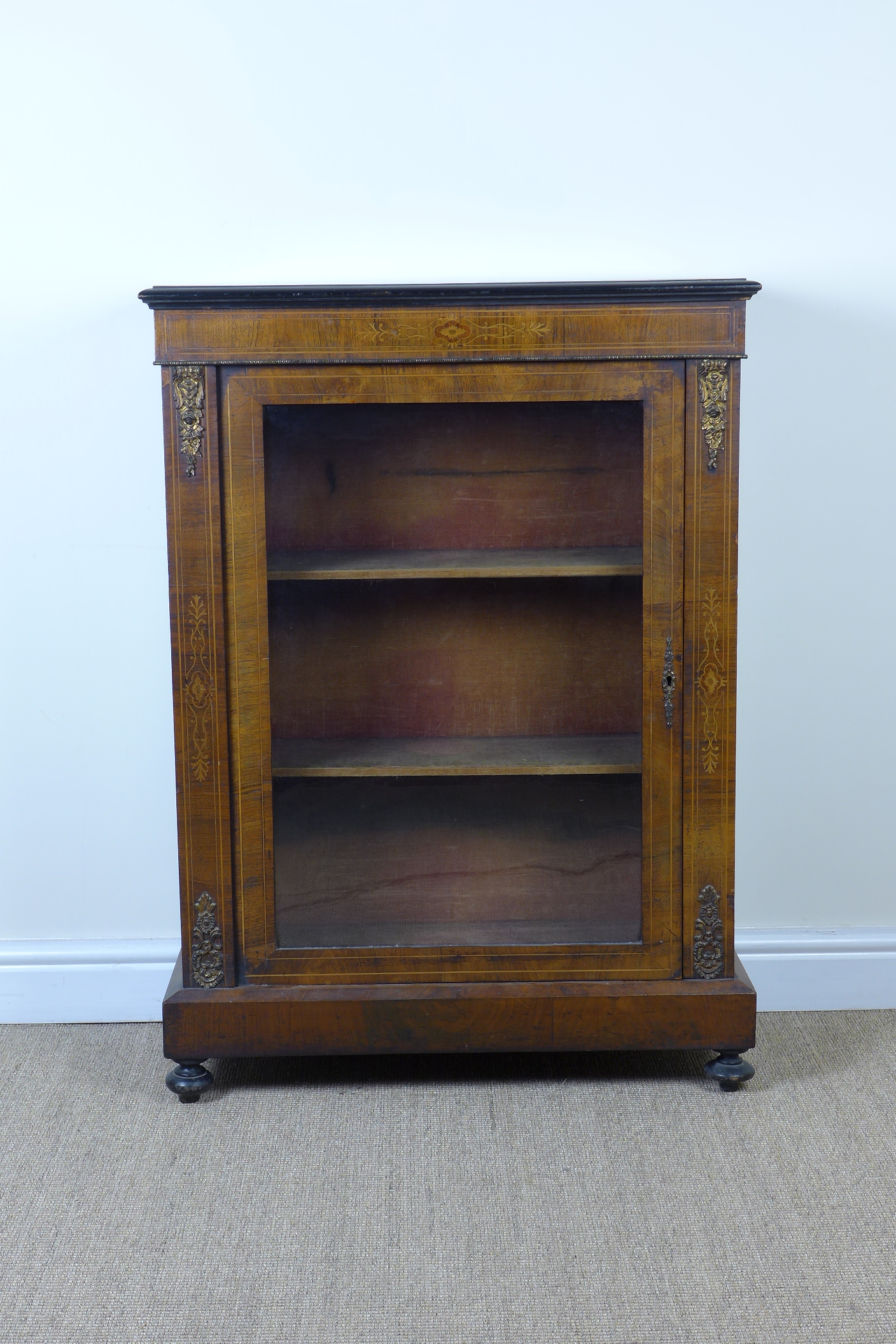A Victorian  walnut Pier Cabinet with inlaid satinwood to the frieze above a single glazed door