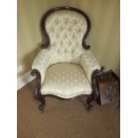 A Victorian mahogany framed Occasional Chair with cream patterned upholstery on cabriole front