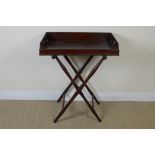 A 19th Century mahogany Butler's Tray with hand holds in folding stand with turned supports , 2ft
